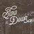 White cursive text that reads “Slow Down” over a faded photograph of trees.