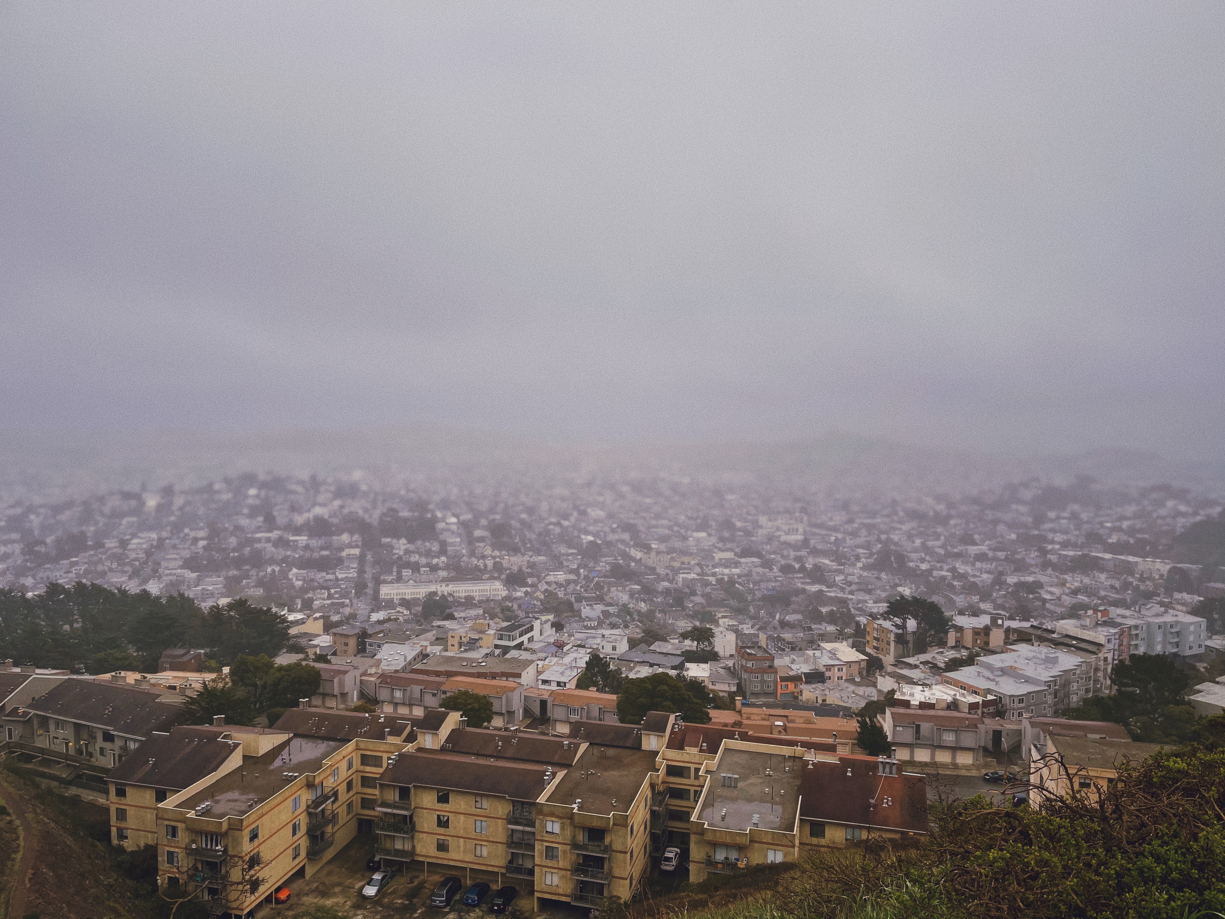 Fog coming towards the camera from the top of Twin Peaks in San Francisco.